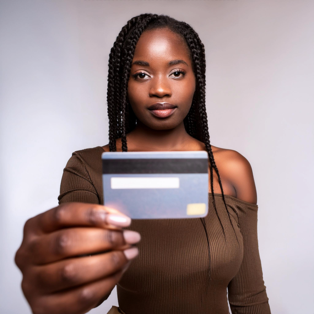 young lady holding up a credit card